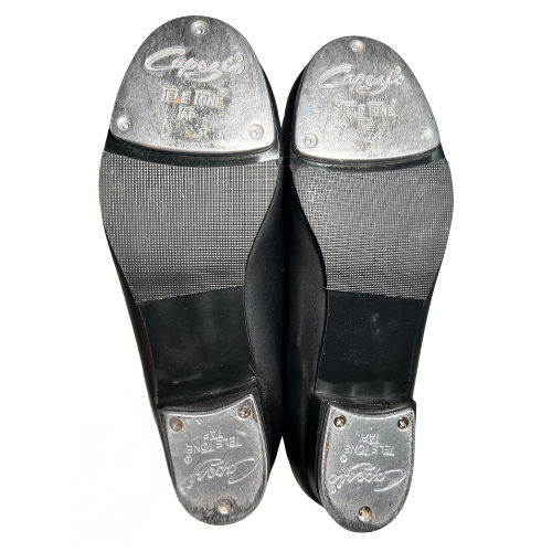 Pre-owned Capezio Tele Tone Tap Shoes in black, size 4.5W for girls, available at Our Families Attic. These gently used shoes feature a durable leather upper and Tele Tone taps for a clear sound, making them ideal for dance classes and performances!