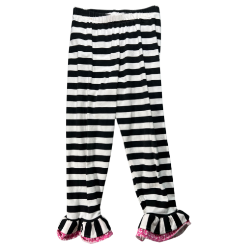 Pre-owned Counting Daisies dress in black, white, and pink with a floral pattern, paired with black and white striped leggings. The dress features cap sleeves, a lace trim, a fabric floral accent, and an attached tie belt. The leggings have an elastic waistband and ruffled hems. Size 6, gently used condition. Shop www.ourfamiliesatticcom