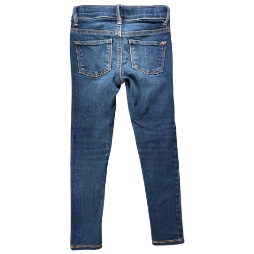Pre-owned Old Navy Rockstar Jeggings for little girls in size 6 Regular. Dark wash denim with an adjustable waist, belt loops, two back pockets, faux front pockets, and a zipper with snap closure. Made from a blend of cotton, polyester, spandex, and other materials. Very good, gently used condition. Shop at www.ourfamiliesattic.com