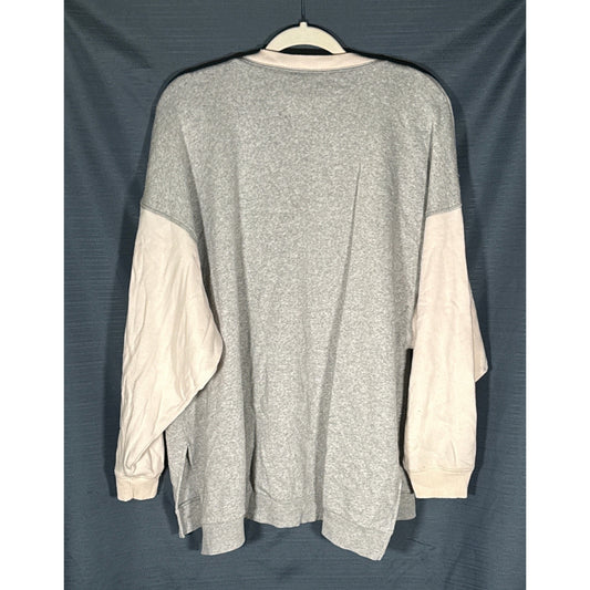 Back view of an American Eagle women’s large sweatshirt with a heather gray body, cream sleeves, and a longer back hem.