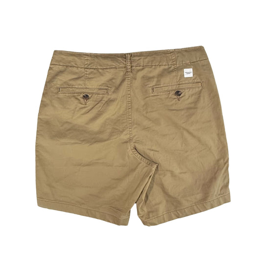 Tan casual shorts back view with button pockets