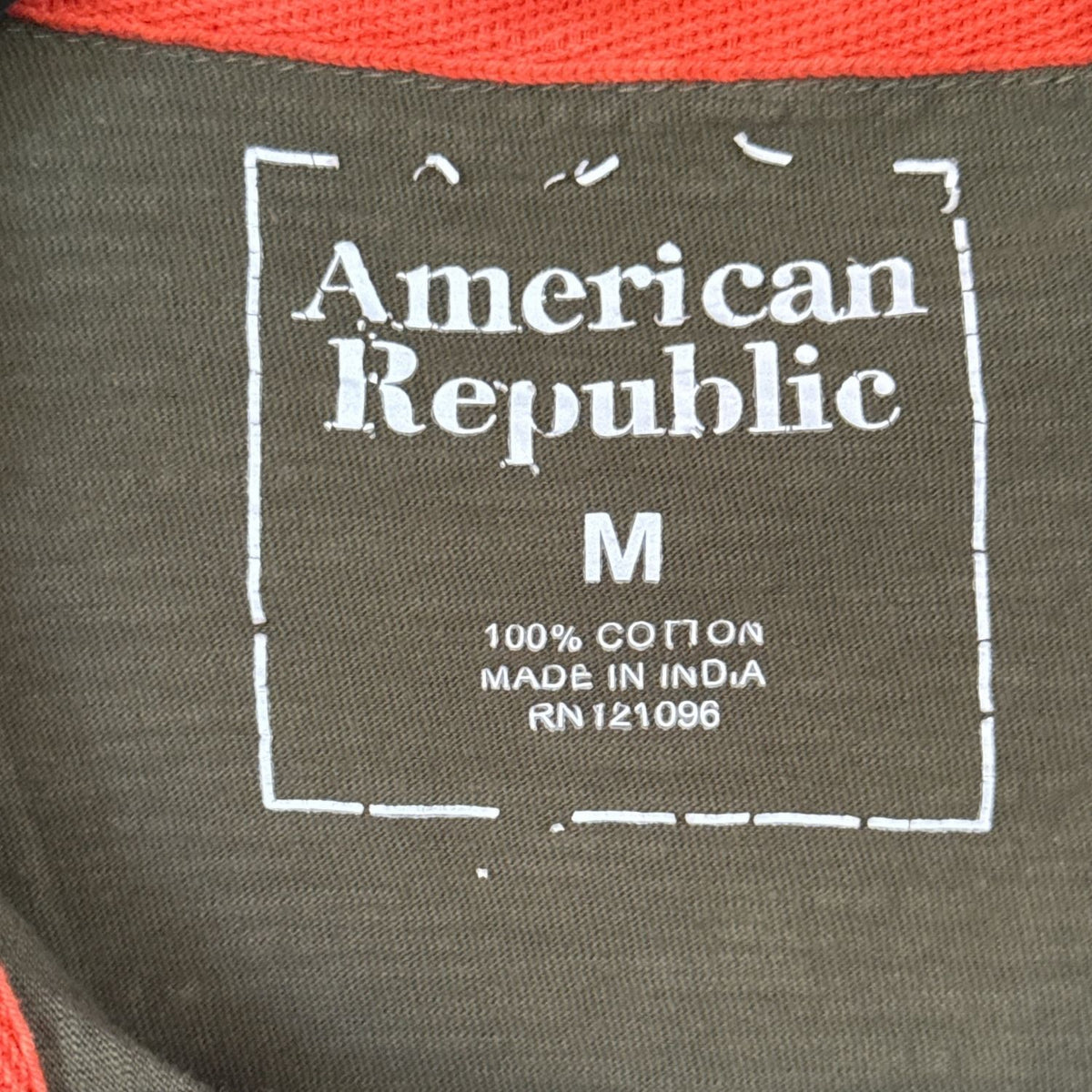 American Republic men’s size Medium polo label showing 100 percent cotton and Made in India