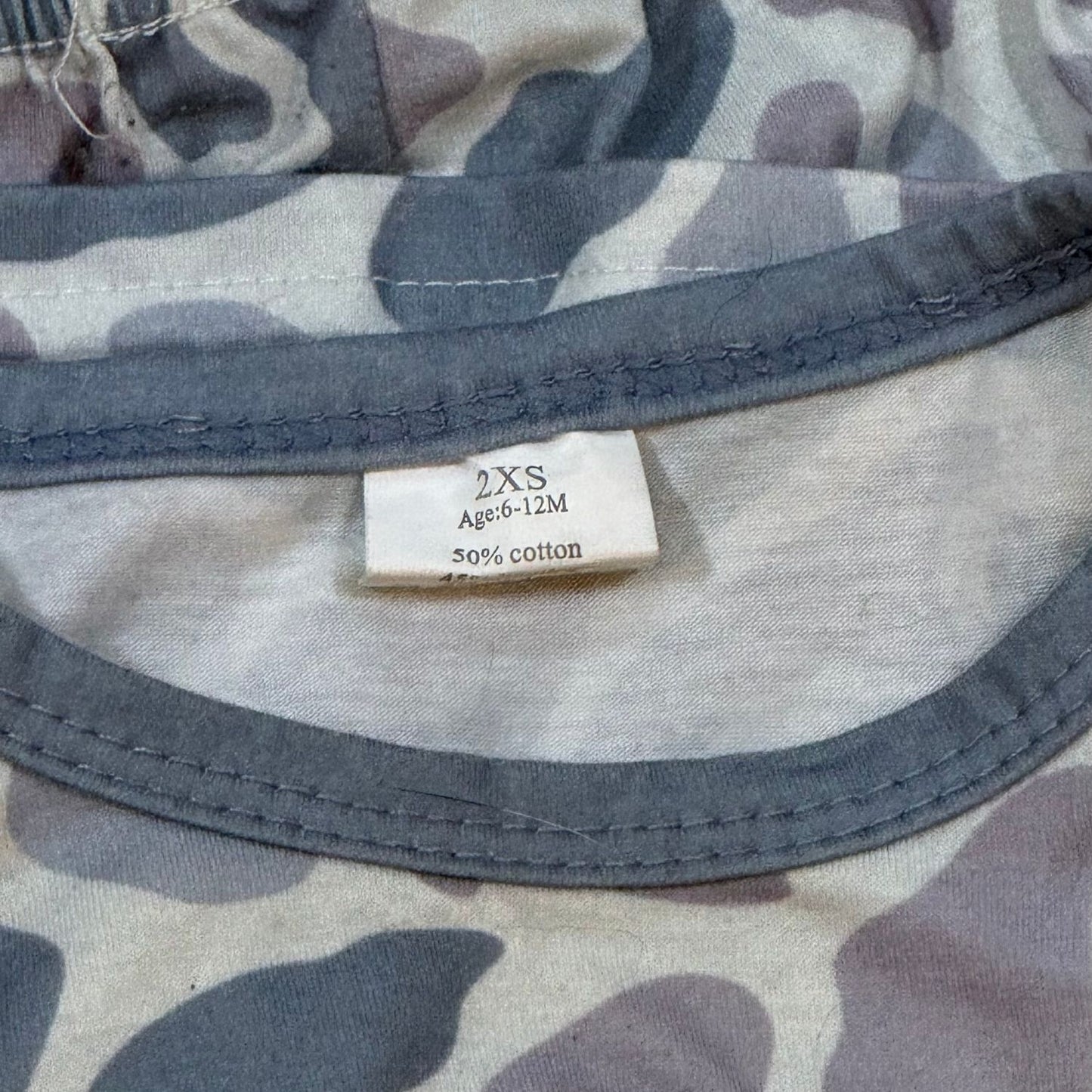 Baby gray camo pajama set size 6-12 months tag showing cotton bamboo blend fabric