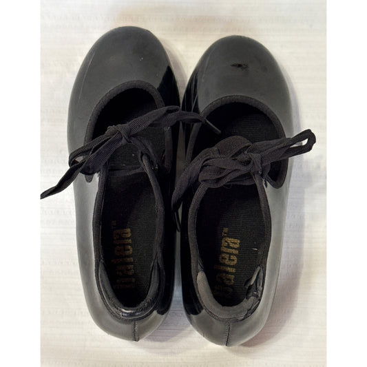 Top view of black Balera tap shoes showing tie laces, elastic instep straps, and heel-opening wear.