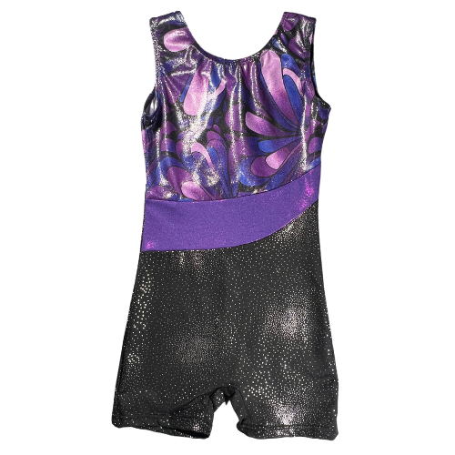 Pre-owned girls' gymnastics leotard size 6-7 in shimmery black with a purple waistband and patterned design on top. Features a tank top and shorts style with a one-piece design, crafted from 82% Polyester and 18% Elasthanne for a comfortable, stretchy fit. Gently used and in good condition, ideal for gymnastics practice or performances. Shop online at ourfamiliesatticcom