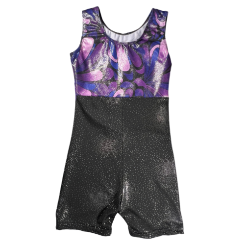 Pre-owned girls' gymnastics leotard size 6-7 in shimmery black with a purple waistband and patterned design on top. Features a tank top and shorts style with a one-piece design, crafted from 82% Polyester and 18% Elasthanne for a comfortable, stretchy fit. Gently used and in good condition, ideal for gymnastics practice or performances. Shop online at ourfamiliesatticcom