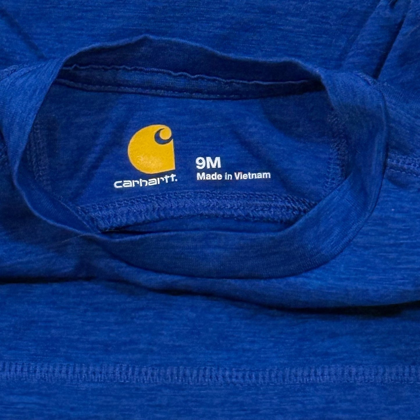 Carhartt brand and 9 month size marking on heather blue baby long sleeve shirt
