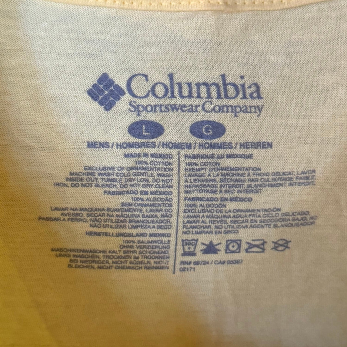 Columbia Sportswear Company men's size Large label showing 100% cotton fabric and garment care instructions inside yellow PFG T-shirt.