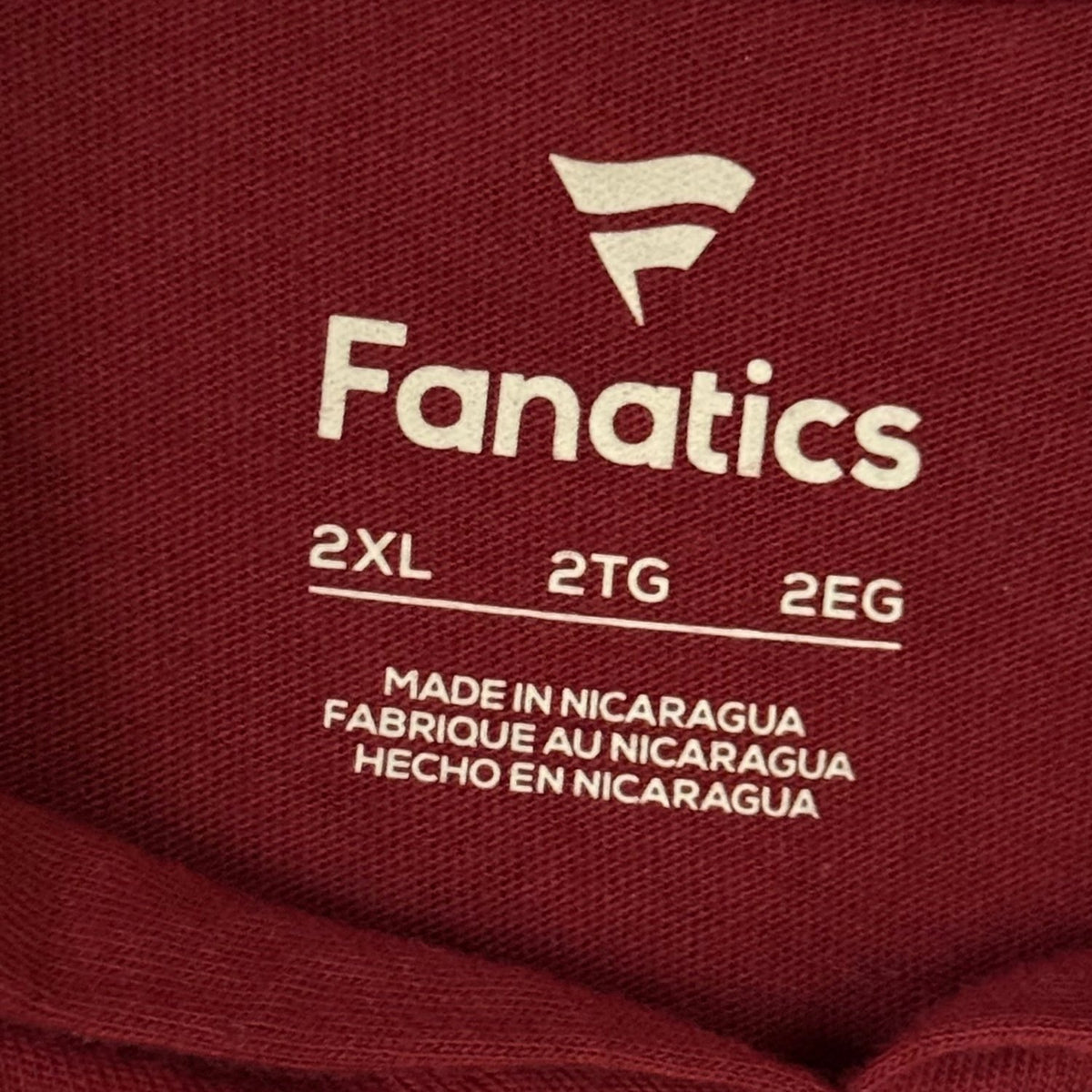 Fanatics men's 2XL size label printed inside burgundy Washington Commanders hooded long sleeve shirt.