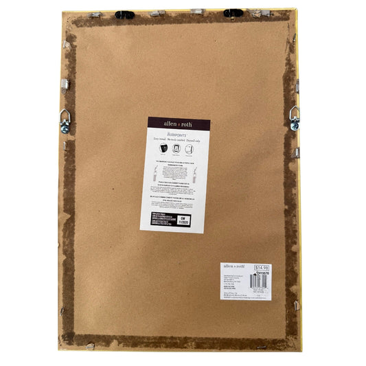 Back of framed wall decor showing faux wood frame and hanging hardware