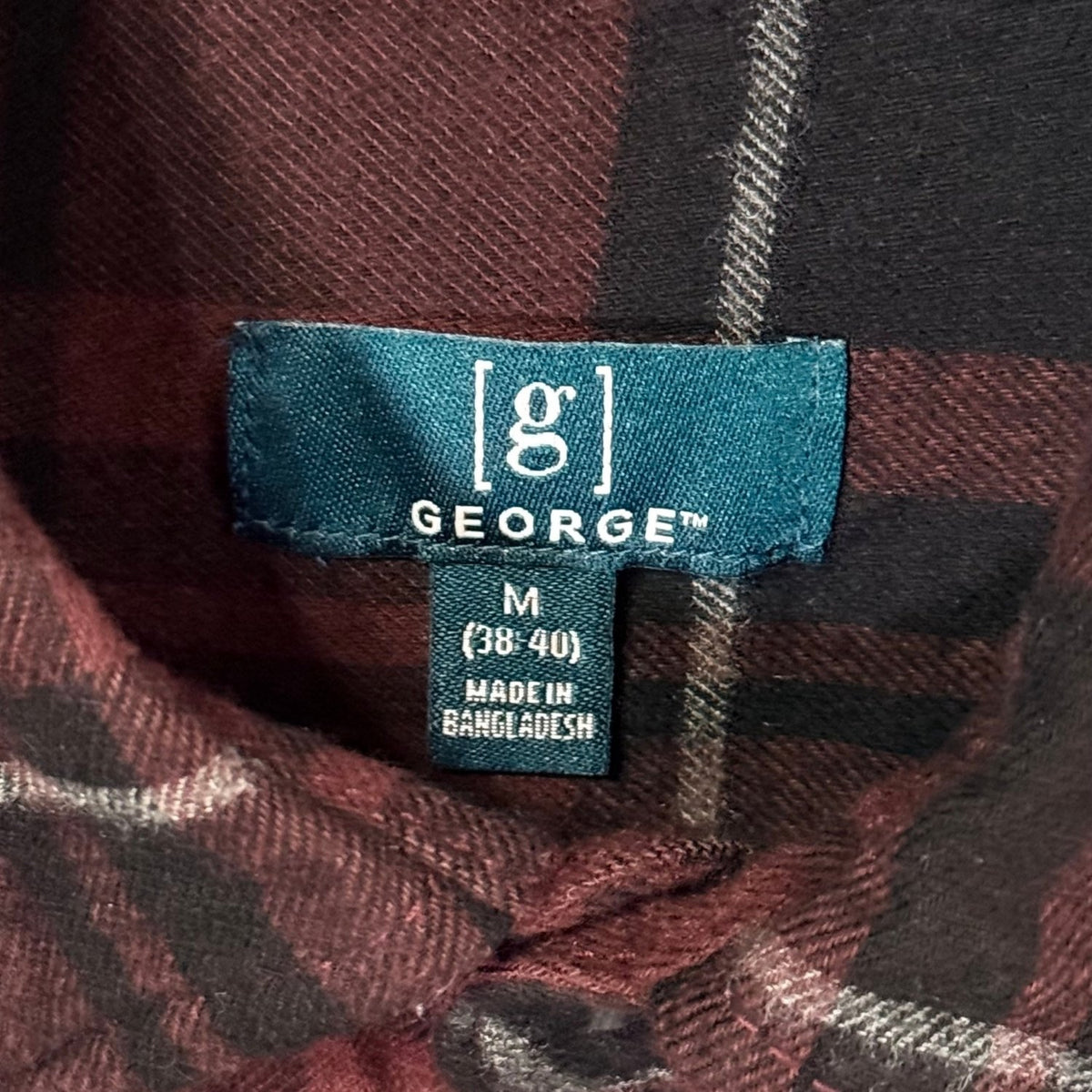 George men's medium size 38–40 brand label inside burgundy and black plaid flannel shirt.