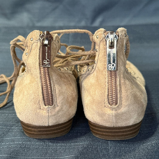 Back view of tan Jessica Simpson suede ballet flats with zipper closures and small metallic studs.