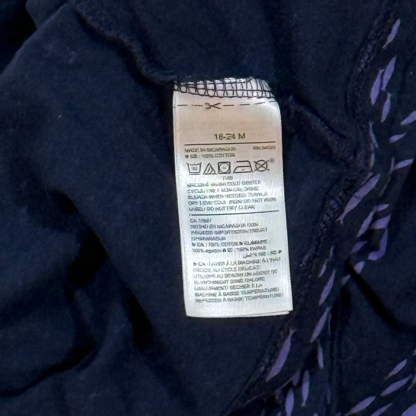Old Navy 18-24 month T-shirt care and material tag showing 100% cotton