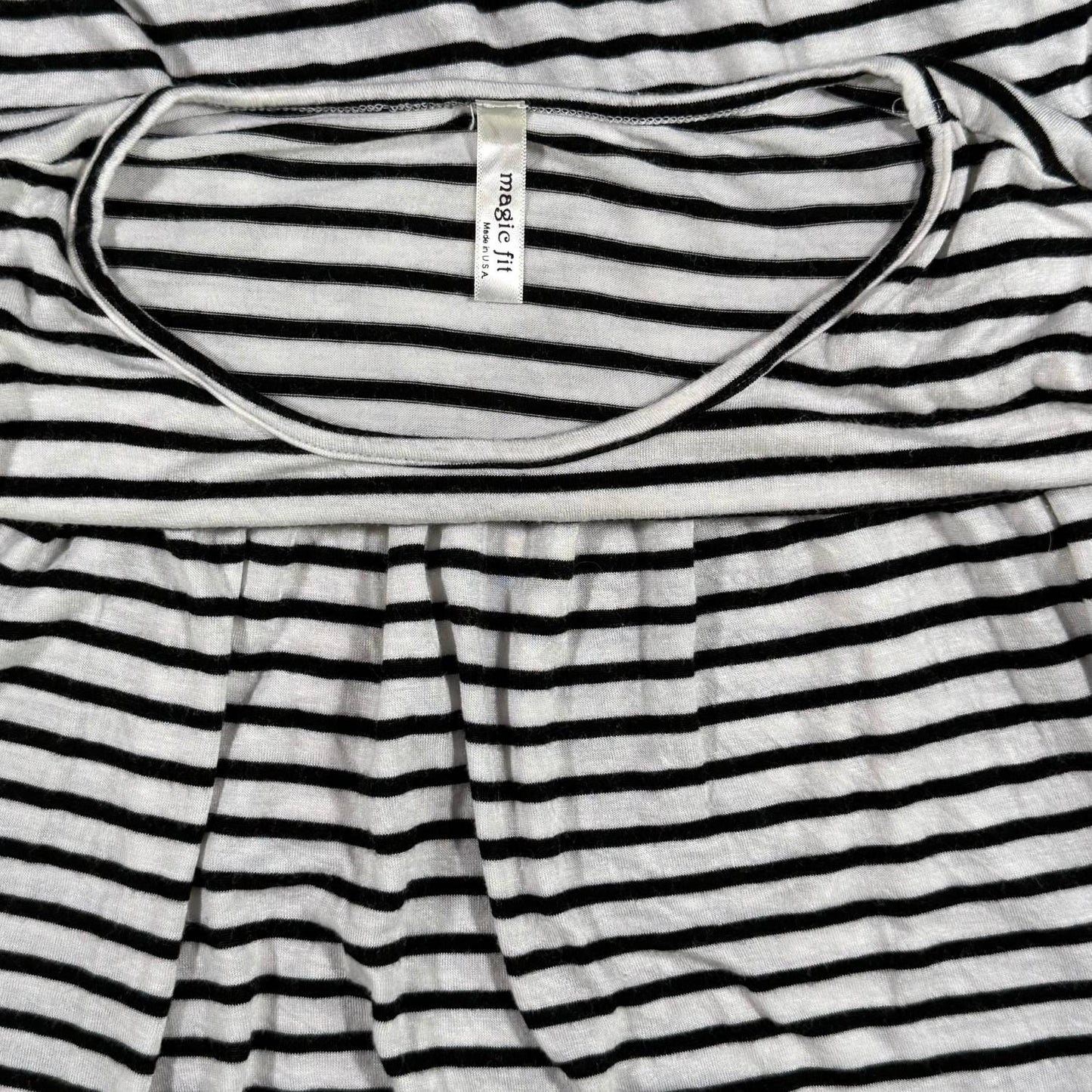 Magic Fit brand tag on a women's large black and white striped peplum top.