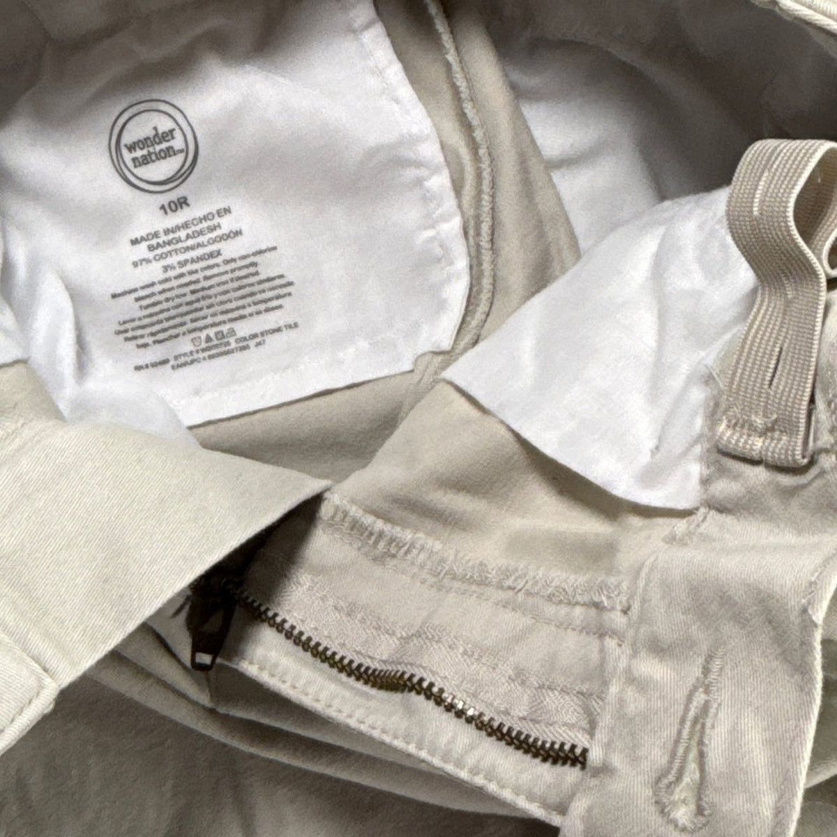 Interior label of Wonder Nation boys’ size 10R pants showing 97% cotton and 3% spandex.