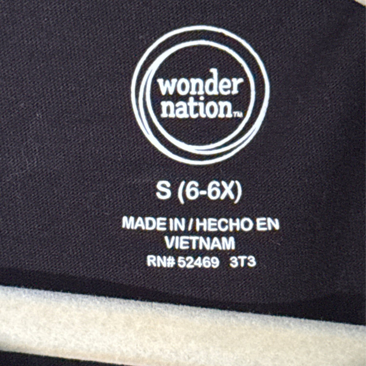 Wonder Nation girls clothing label showing size Small 6–6X inside black T-shirt.