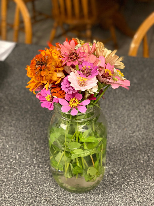 Colorful flowers from Melanie’s garden arranged in a reused Mason jar