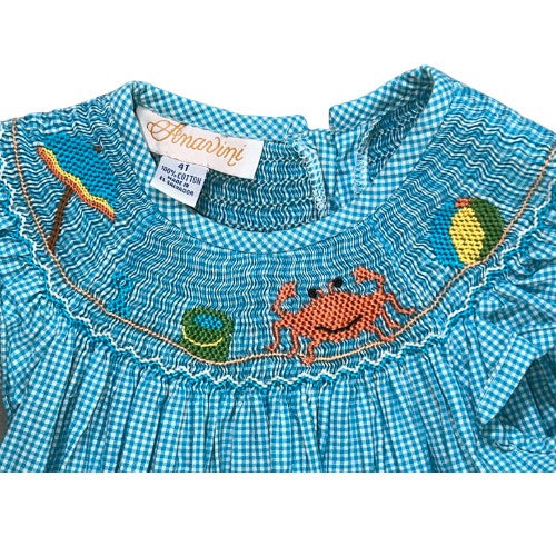 Pre-Owned Smocked Dress Brand: Anavini Size: Toddler girl 4T Color: Blue (more turquoise) and white checkered with embroidered beach images Features: Cap ruffle sleeves, embroidery, hand smocking, 2 button closure on back Material:  100% Cotton Condition:  Great,  Gently used. There is a very light stain on the back.  Online thrift store - Our Families Attic