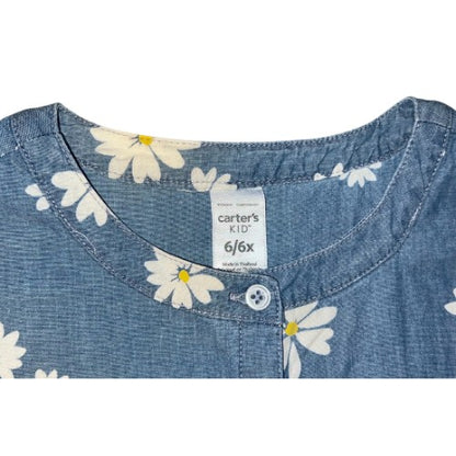 Pre-Owned Blue Denim-Look Dress  Brand: Carter's Kid Size: Little Girl 6-6x Color: Light blue (denim look) with white daisy print Features: Cap sleeve, lightweight, front top button closure, tie in front Material: 100% Cotton Condition:   Gently used. There are a couple of very small snags on the front of the skirt. Used clothes. Our Families Attic.