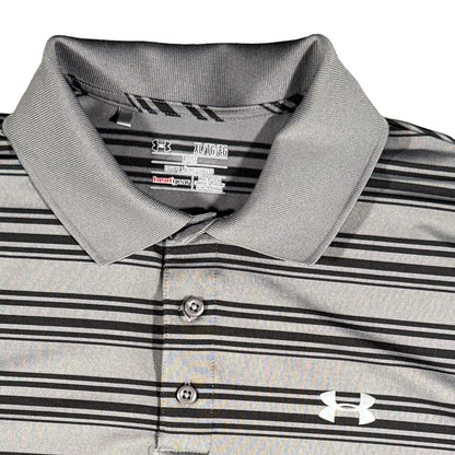 Close-up of the embroidered Under Armour logo and collar on a gray striped HeatGear performance polo.