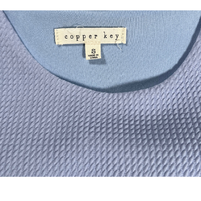 Copper Key girl's small blue dress with pink and orange flowers. Stretchy material, lined, and pleated skirt. Sleeveless. Round neck. tag view. Gently used excellent condition. Shop Our Families Attic. 