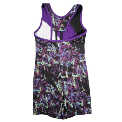 Pre-Owned Danskin Now Girls' Gymnastics Leotard in Black and Purple with Multicolor Geometric Design. Size 6-6X. Features a one-piece tank top and shorts design with an athletic cutout back. Made of 84% polyester and 16% spandex. Worn very little with minor popped stitches; overall in good condition. Our Families Attic.