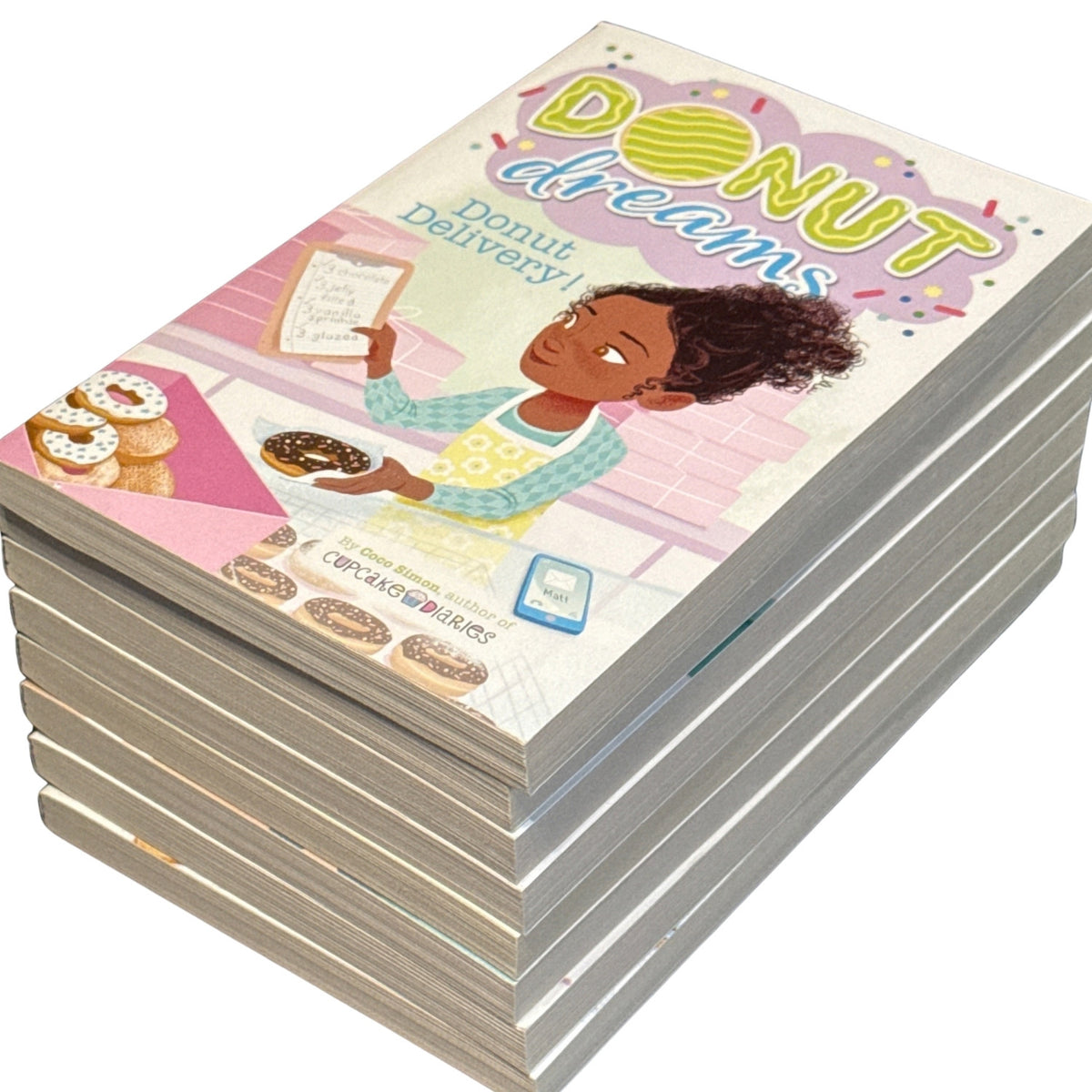 Eight Donut Dreams paperback books stacked with Donut Delivery! by Coco Simon on top and page edges visible.
