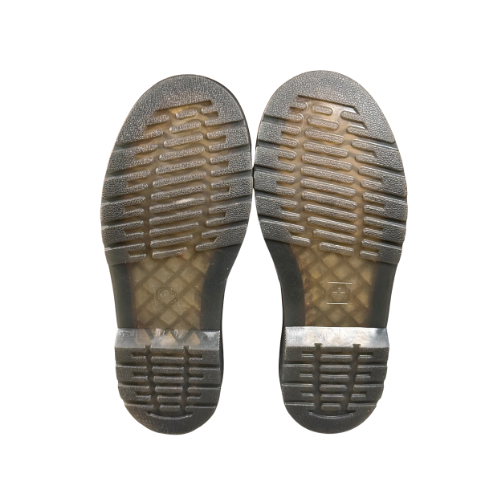 Bottom of Dr. Martens 1460 tie-dye boots showing tread and minimal wear