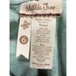 Close-up of a Metilda Jane clothing tag on a teal fabric background