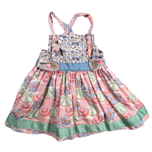 Pre-owned Matilda Jane Parasol Knot Top for girls, size 6, featuring a light multicolor design of pink, green, and blue, with a charming knot detail, decorative buttons, and crisscross straps, available at Our Families Attic.