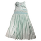 Mint green dress with smocked bodice on a white background