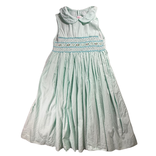 Mint green dress with smocked bodice on a white background