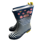 Pre-owned Time & True ladies rain boots, size 7, featuring a dark blue background with pink and yellow floral print on the upper section and bold white and dark blue stripes on the lower section. Boots include yellow pull loops and yellow accents on the soles. Shop ourfamiliesattic.com