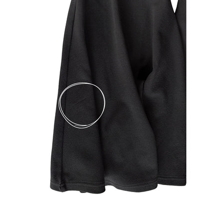 Close-up of small snag on lower back left flare of SHEIN black flare pants women’s XL
