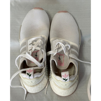 Rear and top view of Adidas sneakers showing heel tabs with pink flowers and green stems.