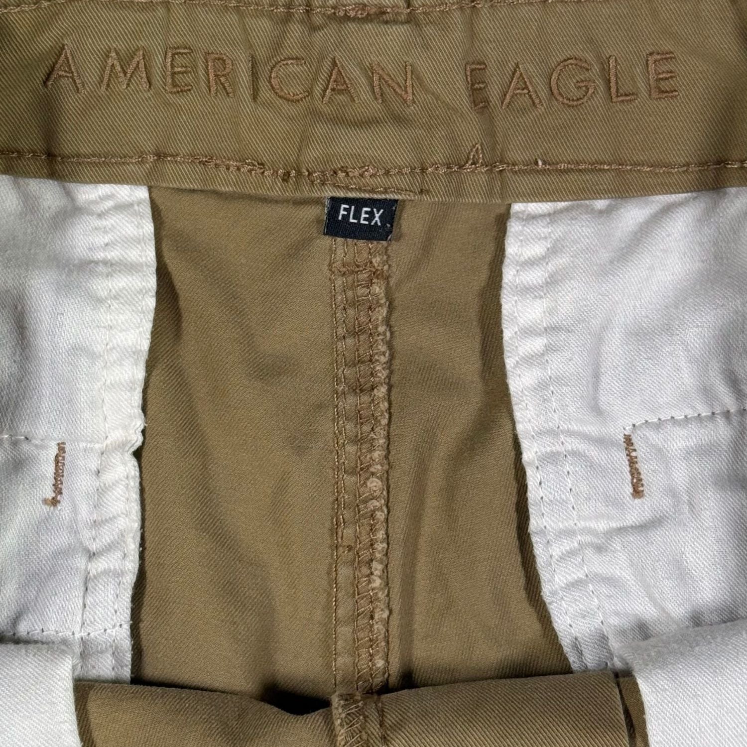 Close-up of a brown fabric with 'American Eagle' branding and a 'Flex' label.