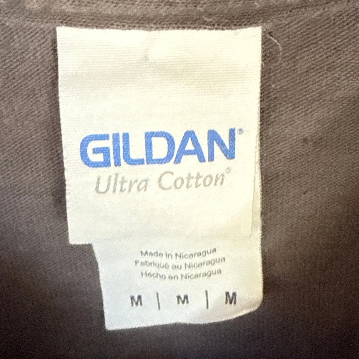 Gildan Ultra Cotton adult size Medium label on charcoal-gray long-sleeve shirt