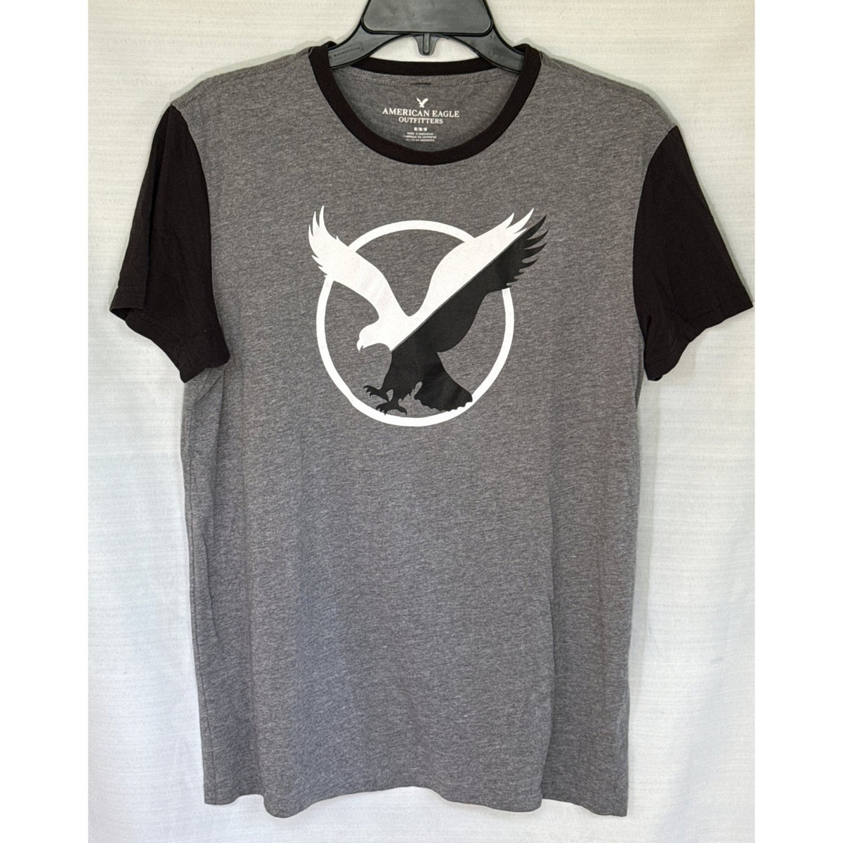 Front of American Eagle Outfitters men’s medium heather gray and black T-shirt with large black-and-white eagle graphic