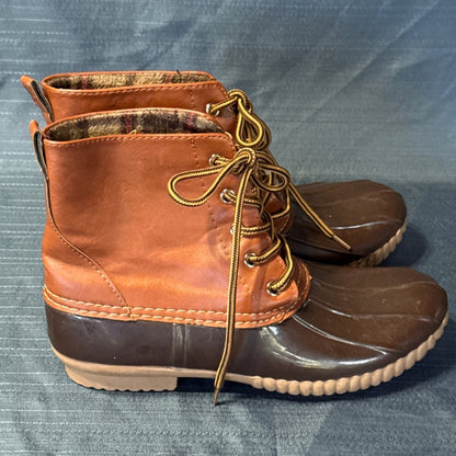 Side profiles of brown ANNA lace-up duck boots with dark brown rubber bottoms and tan soles.