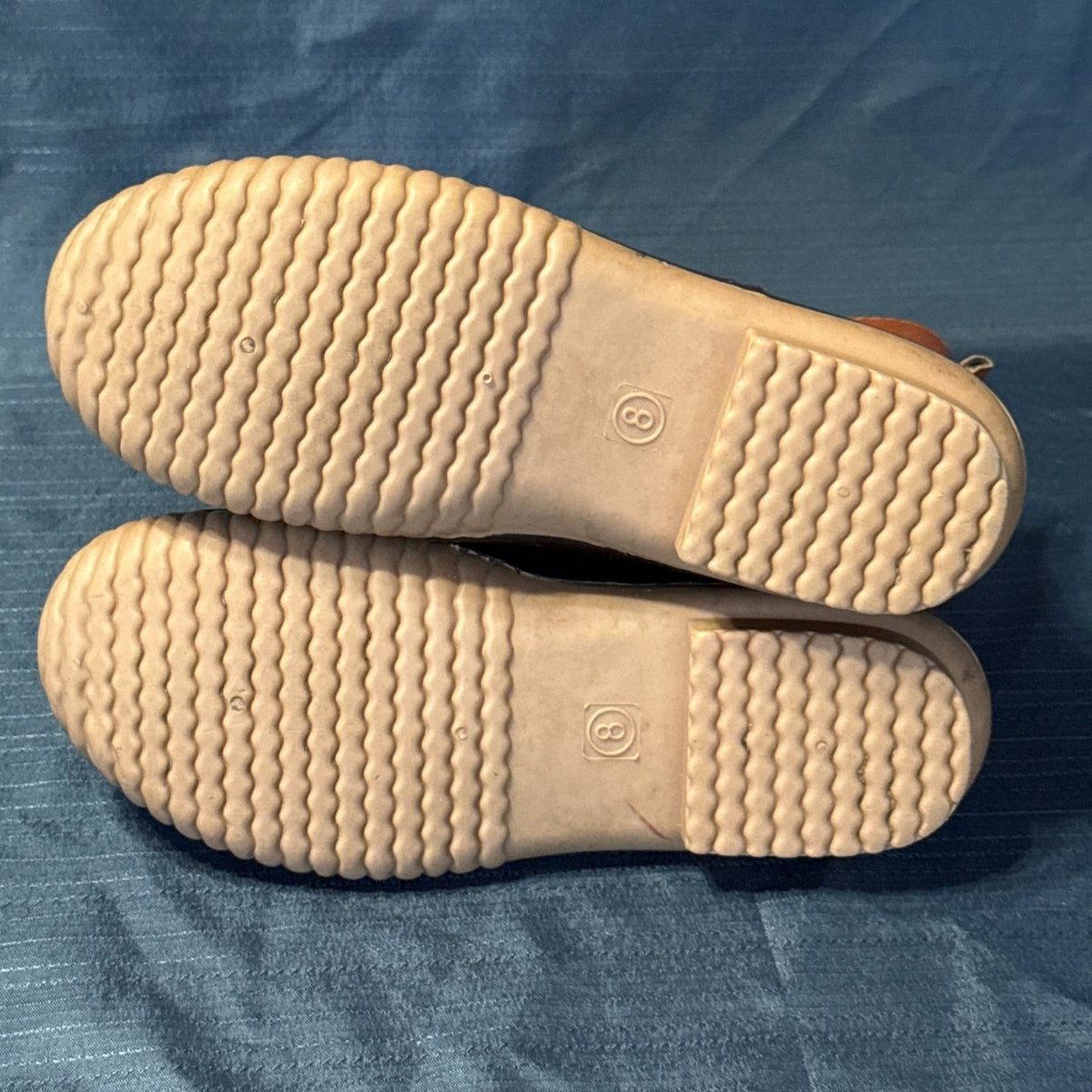 Tan outsoles of ANNA duck boots showing wavy tread and size 8 markings.