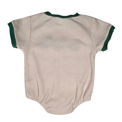 Cream baby onesie with green trim back view