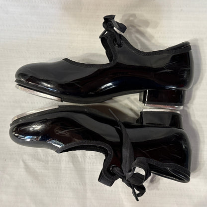 Inner side view of Balera black tie tap shoes showing low heels and metal tap edges.
