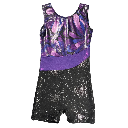 Pre-owned girls' gymnastics leotard size 6-7 in shimmery black with a purple waistband and patterned design on top. Features a tank top and shorts style with a one-piece design, crafted from 82% Polyester and 18% Elasthanne for a comfortable, stretchy fit. Gently used and in good condition, ideal for gymnastics practice or performances. Shop online at ourfamiliesatticcom 