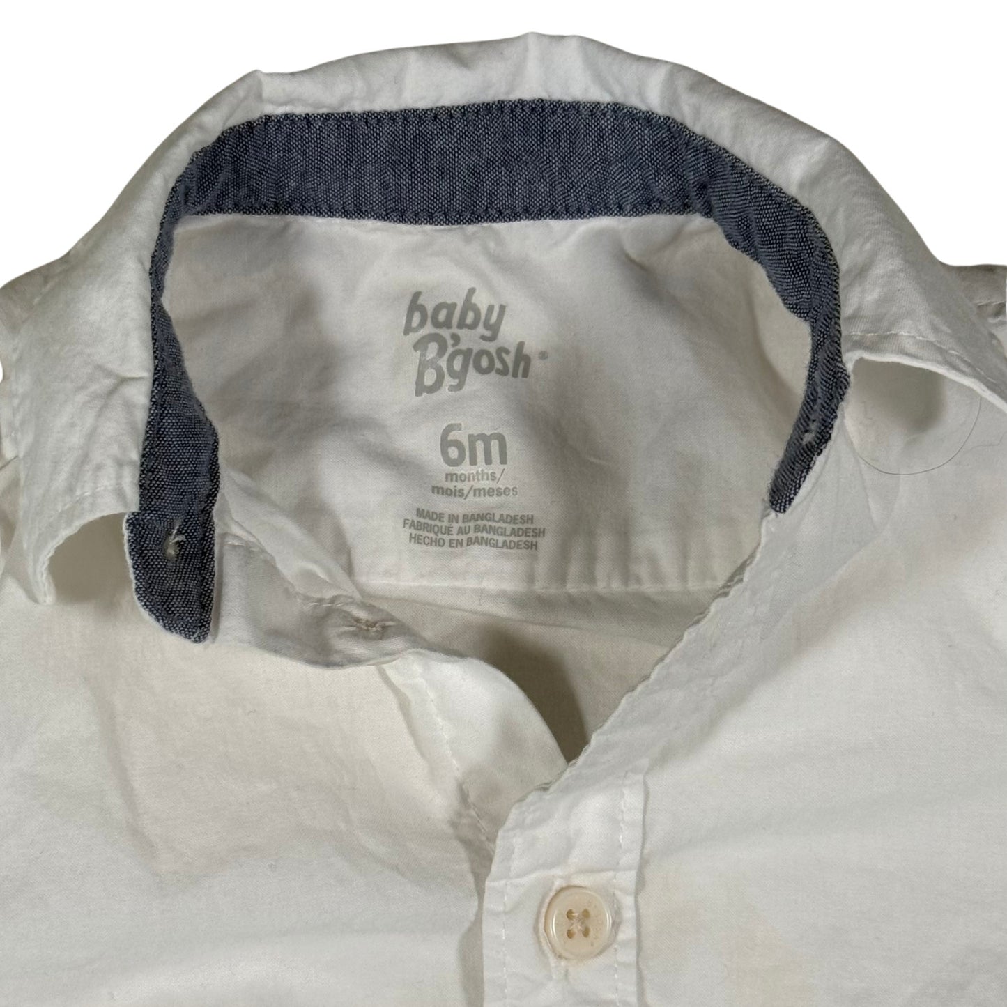 Blue jean trim on collar and wrist of baby onesie tag