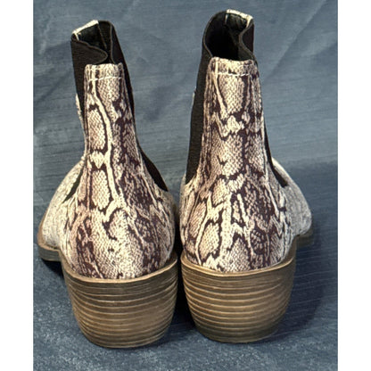 Back view of black-and-tan snake-print ankle boots with brown stacked-look block heels.
