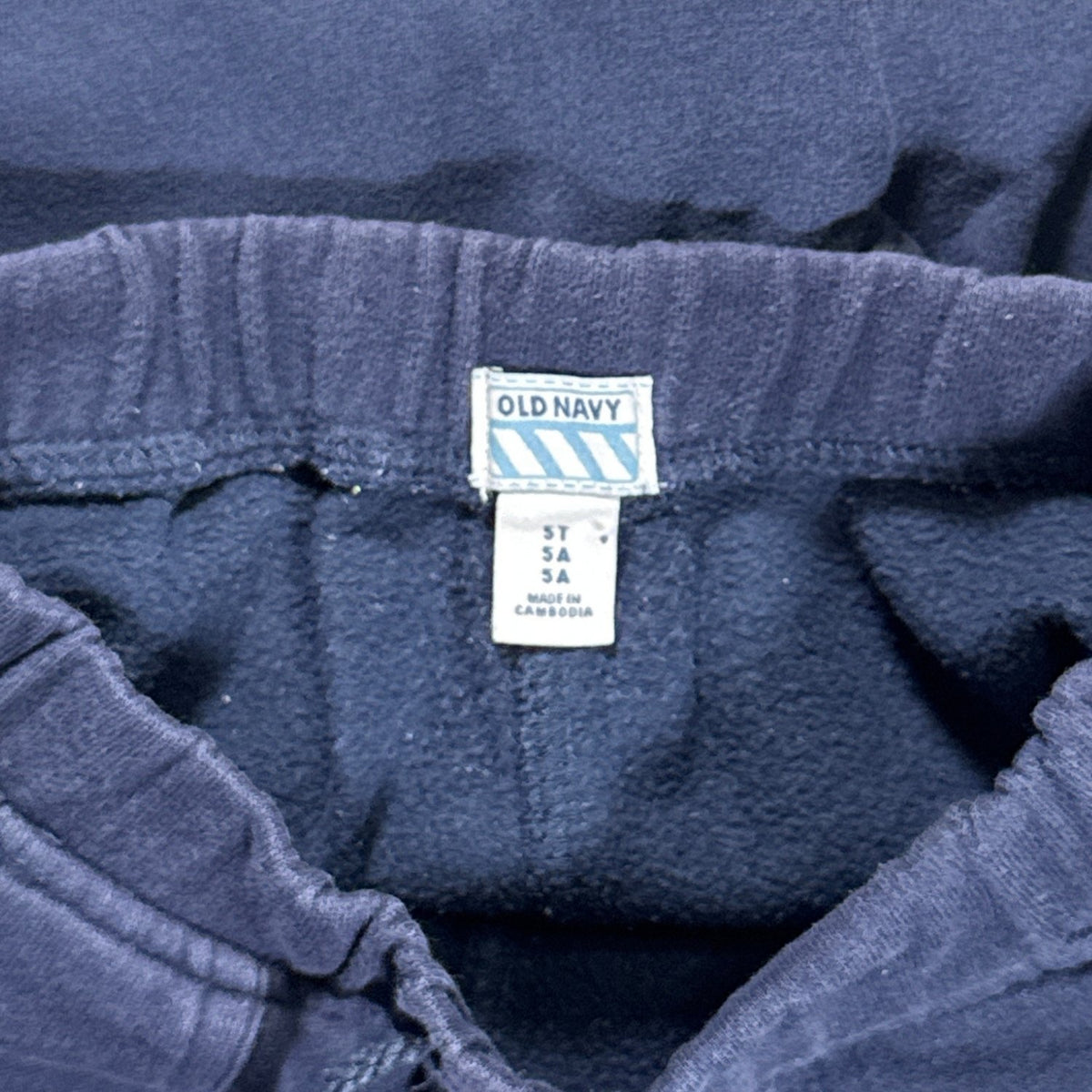 Old Navy size 5T brand and size tag inside the blue sweatpants.