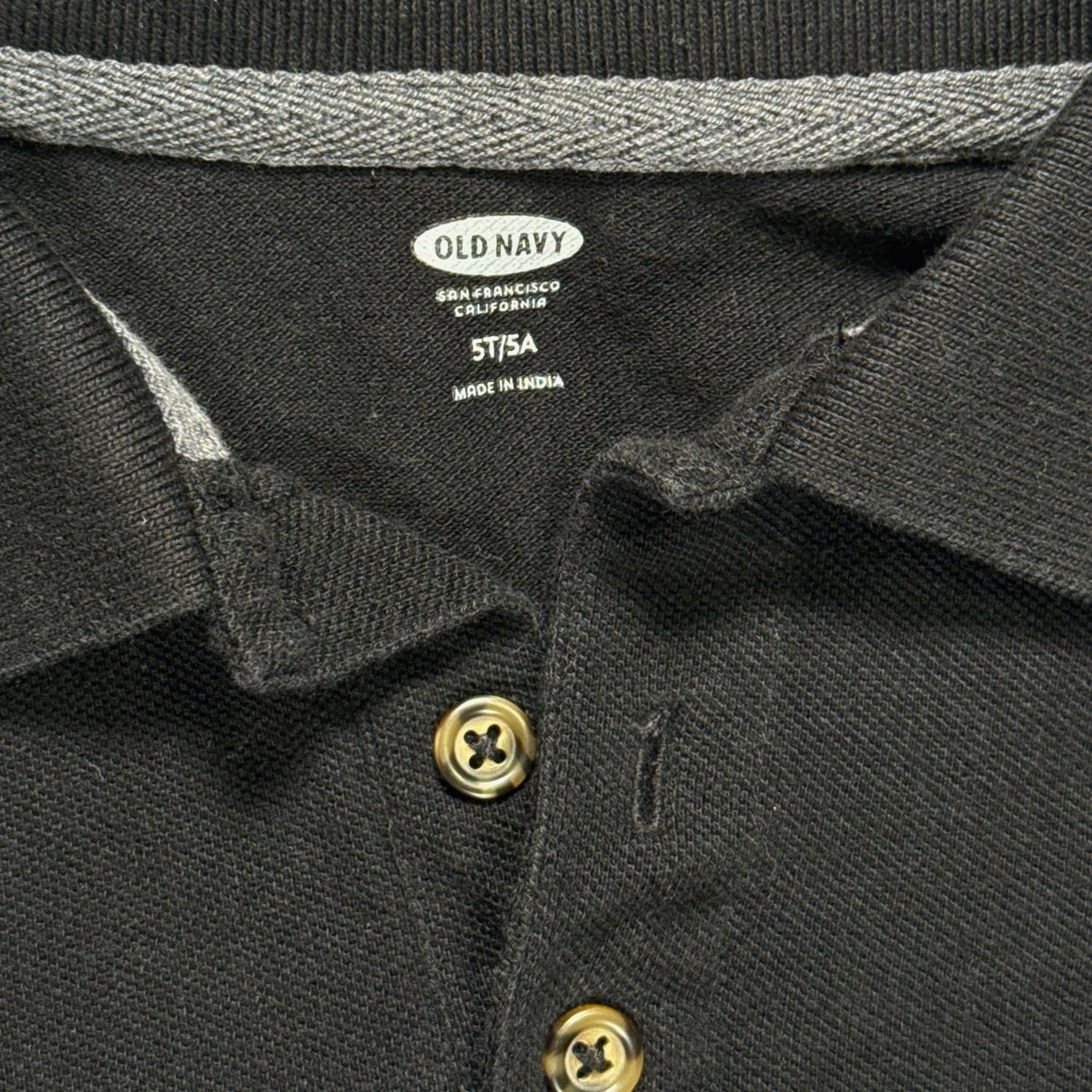 Old Navy black long-sleeve polo label showing boys size 5T