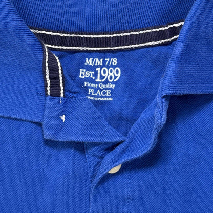Close-up of The Children’s Place M/M 7/8 printed label inside the royal blue polo.