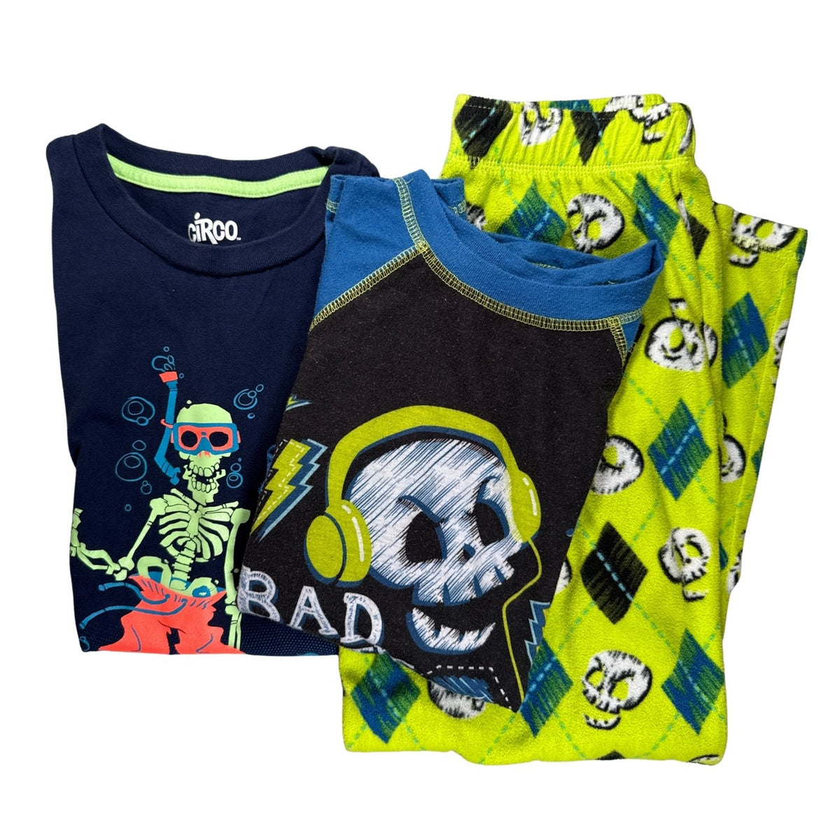 Circo boys Medium 8/10 three-piece skeleton bundle with a navy graphic T-shirt, blue and black pajama top, and lime-green pajama pants