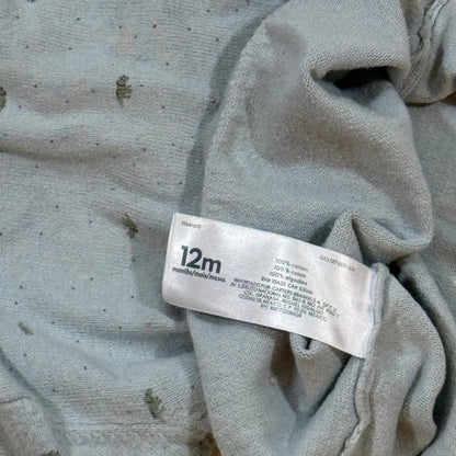 Carter's 12 month dinosaur sweater care and material tag showing 100% cotton